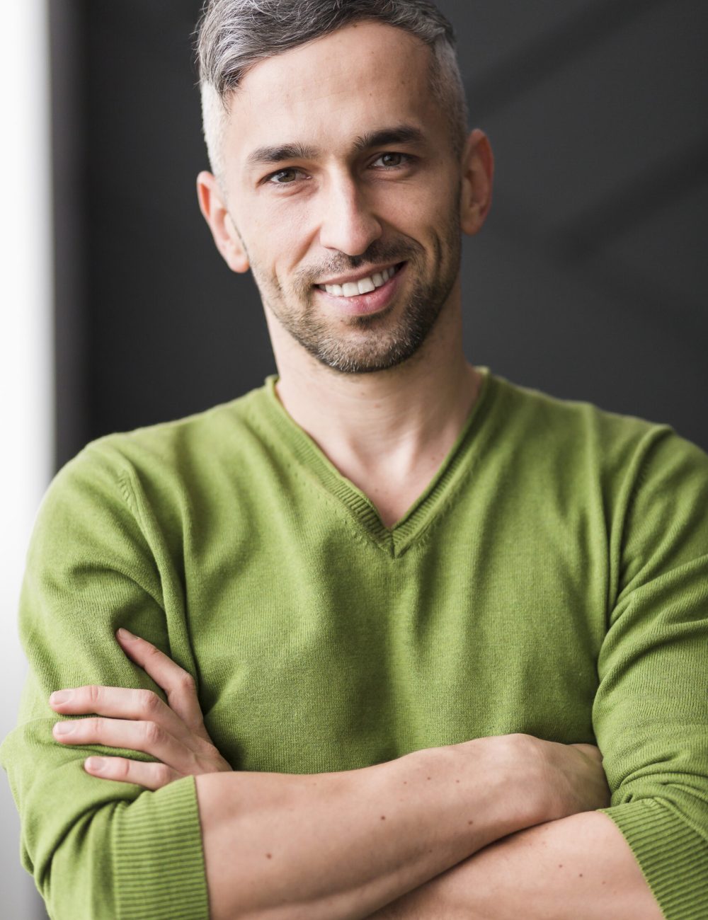 man-green-shirt-having-his-arms-crossed